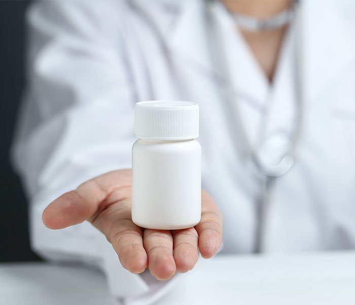 female-doctor-holding-showing-medicine-bottle