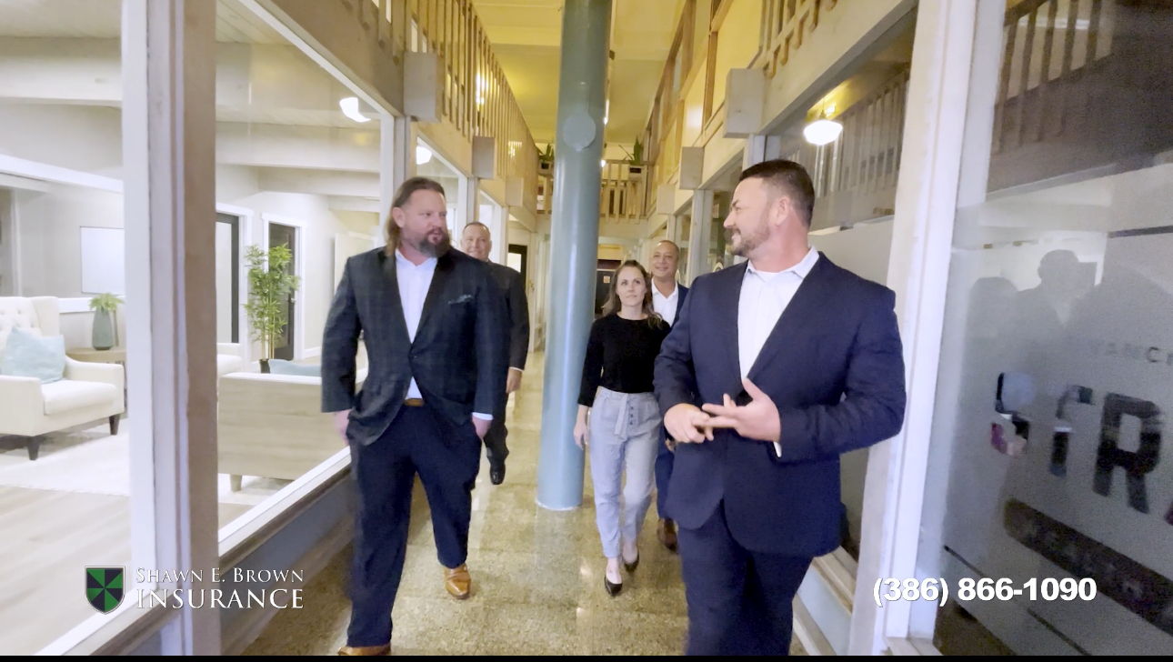 In this image Agency Princpal, Shawn E Brown and Agency General Manager, Joe de Cillis walk through the hallways of the history Kress building in Downtown Daytona Beach, FL. Following closely behind Mark Hamm, Ernest Tiesner and Kimberly Penny observe the conversation.
